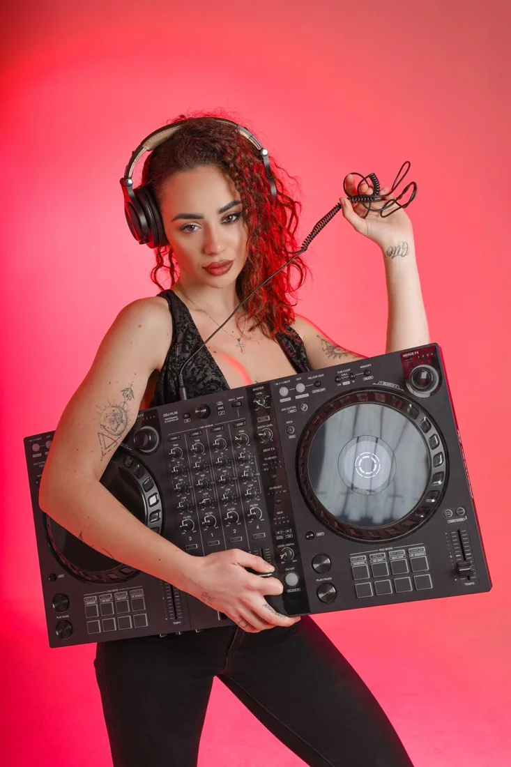 DJ wearing OneOdio headphones while holding a record
